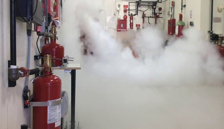 10-second clean agent total flooding gas discharge test in progress inside electronic equipment testing enclosure